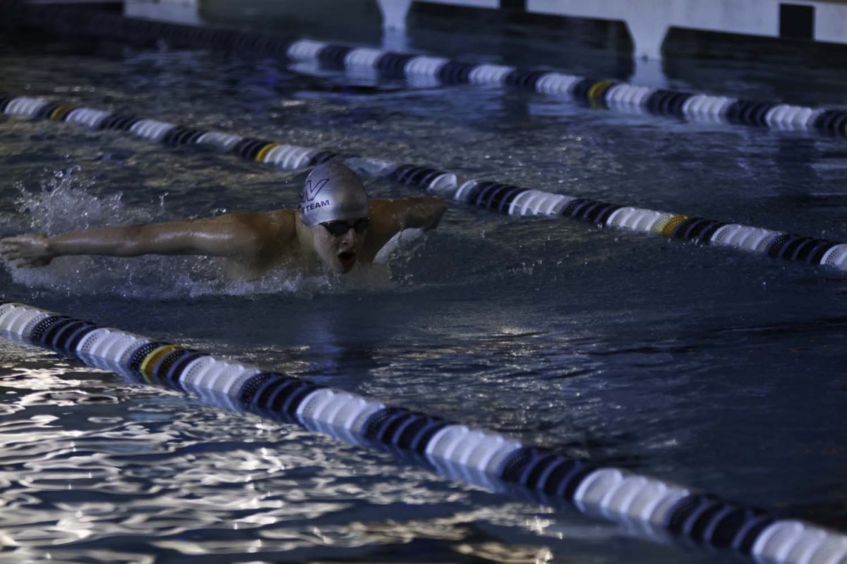 Junior Lucas Agre warms up before his race