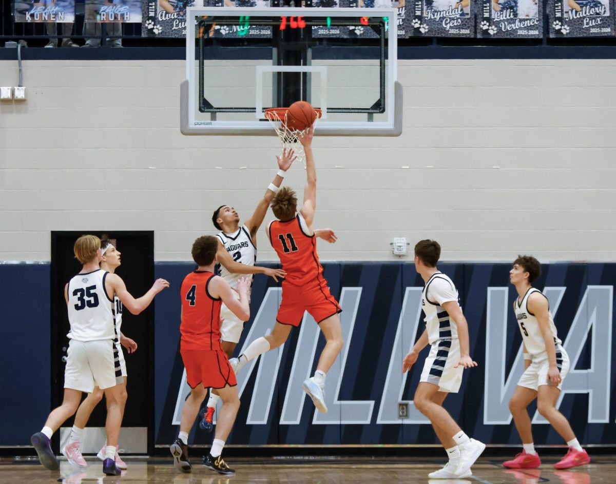 Senior JaKhai Carter jumps to block a dunk