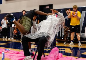 Whipped cream flying everywhere, sophomore Lacina Coulibaly aggressively pies coach Kobe Boyce, earning cheers from the crowd of students and staff.