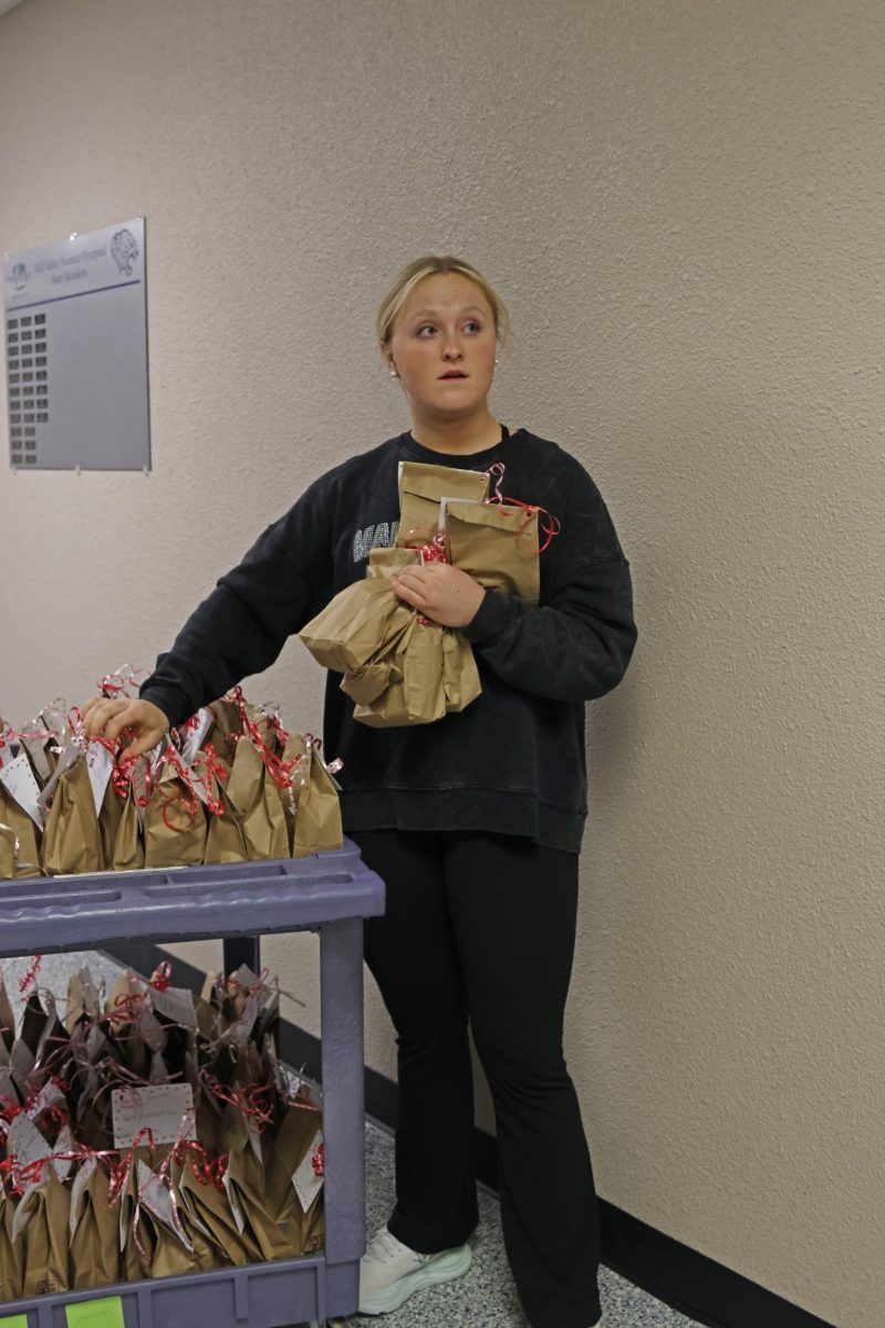Junior Morgan Hennes scans the hallway to find the room the students are in on Feb. 11.