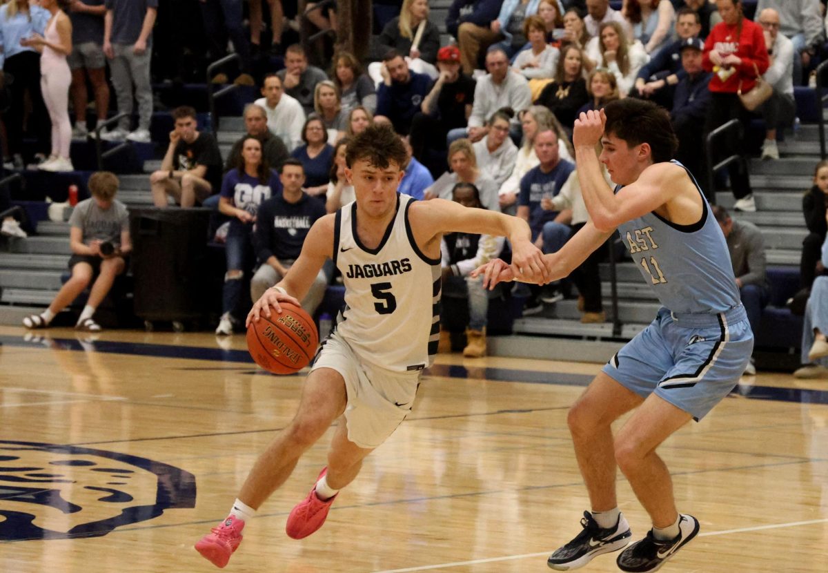 Passing his defender, senior Reece Riedel is able to score, Friday Feb. 13. 