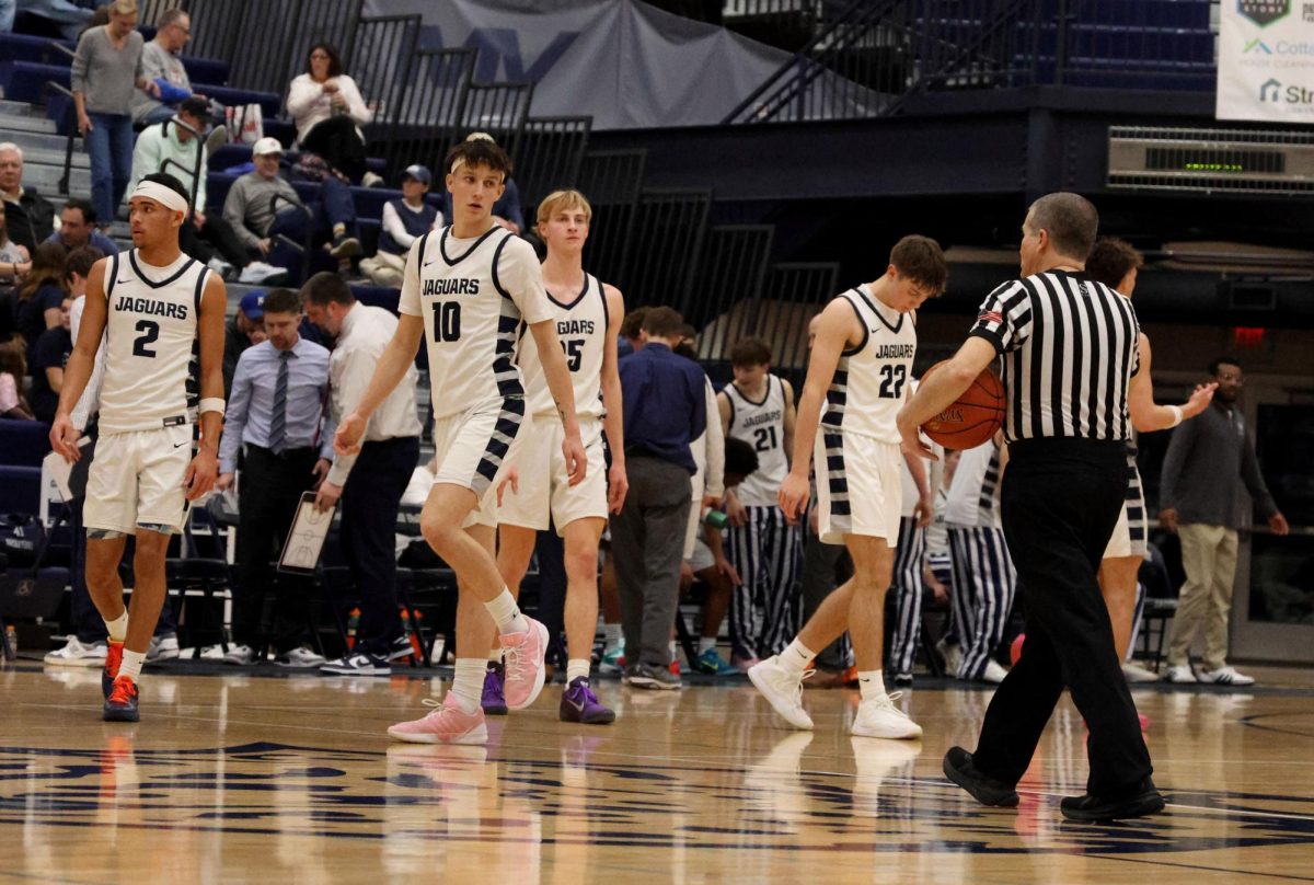 The Jaguar starters prepare to take the floor after warmups. 