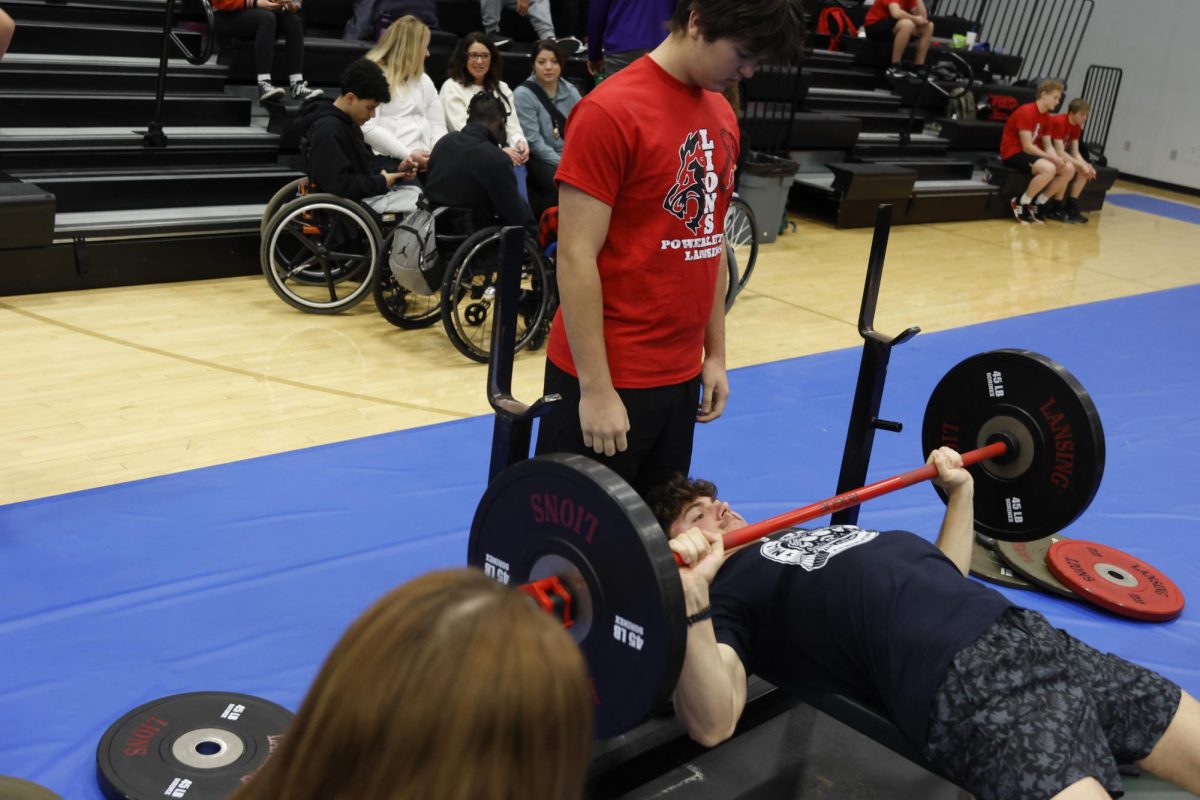Senior Hayden Horn warms up with 135lbs  at the Lansing meet on saturday Feb. 7