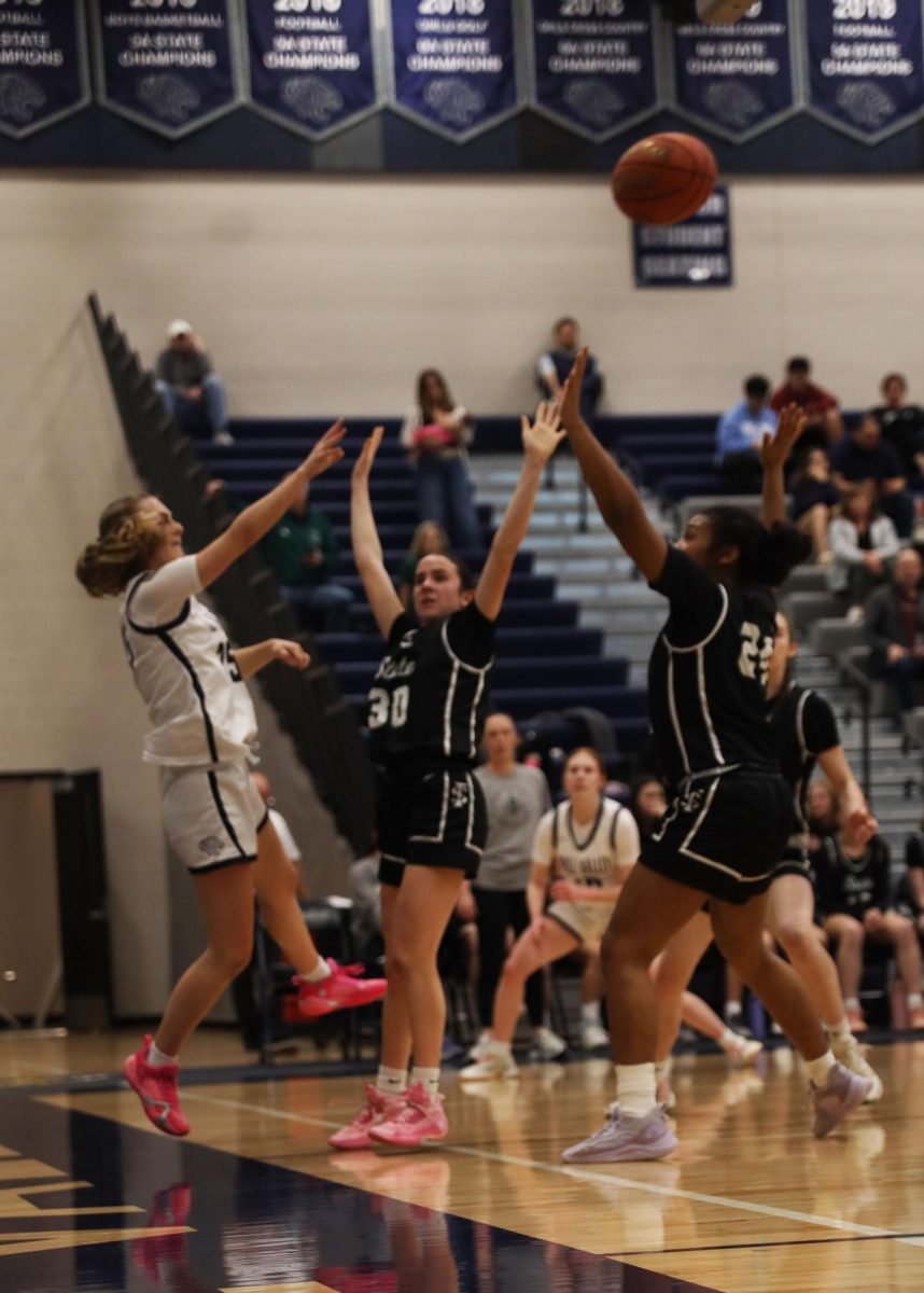 As the defense closes in, junior Riley Marshall passes the ball to one of her teammates before she is pushed to the end line. 