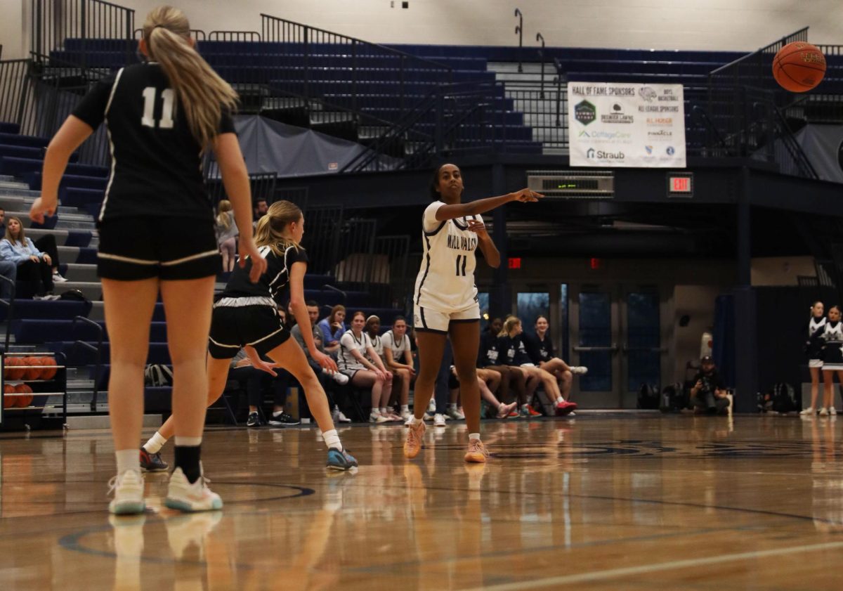 Jogging towards the hoop, junior Biti Hasabu makes a no-look pass to her teammate.