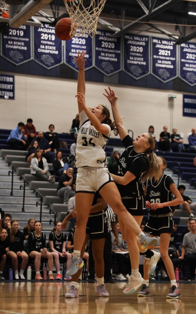 Extending her arm, sophomore Emily Izatt scores her layup shot.
