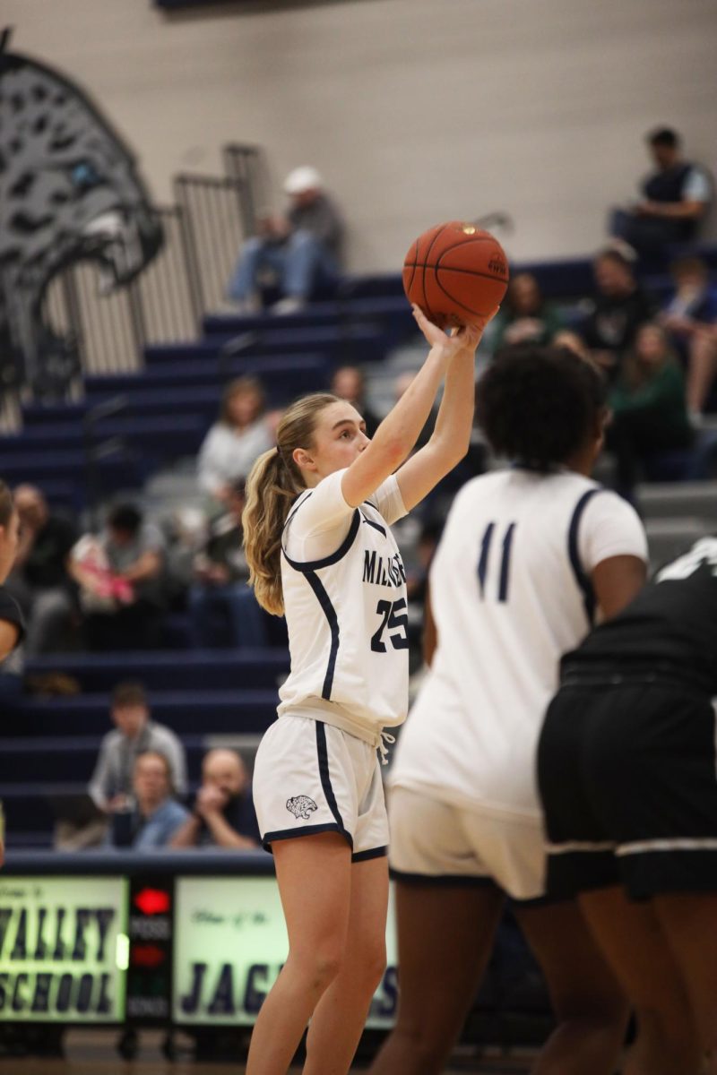 Ball raised above her head, junior Riley Marshall shoots her free-throw. 