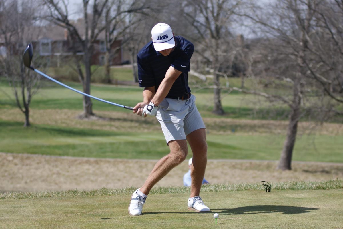 Junior Eli Platz takes his first swing of the hole at Lawrence Country Club, Monday, March 30