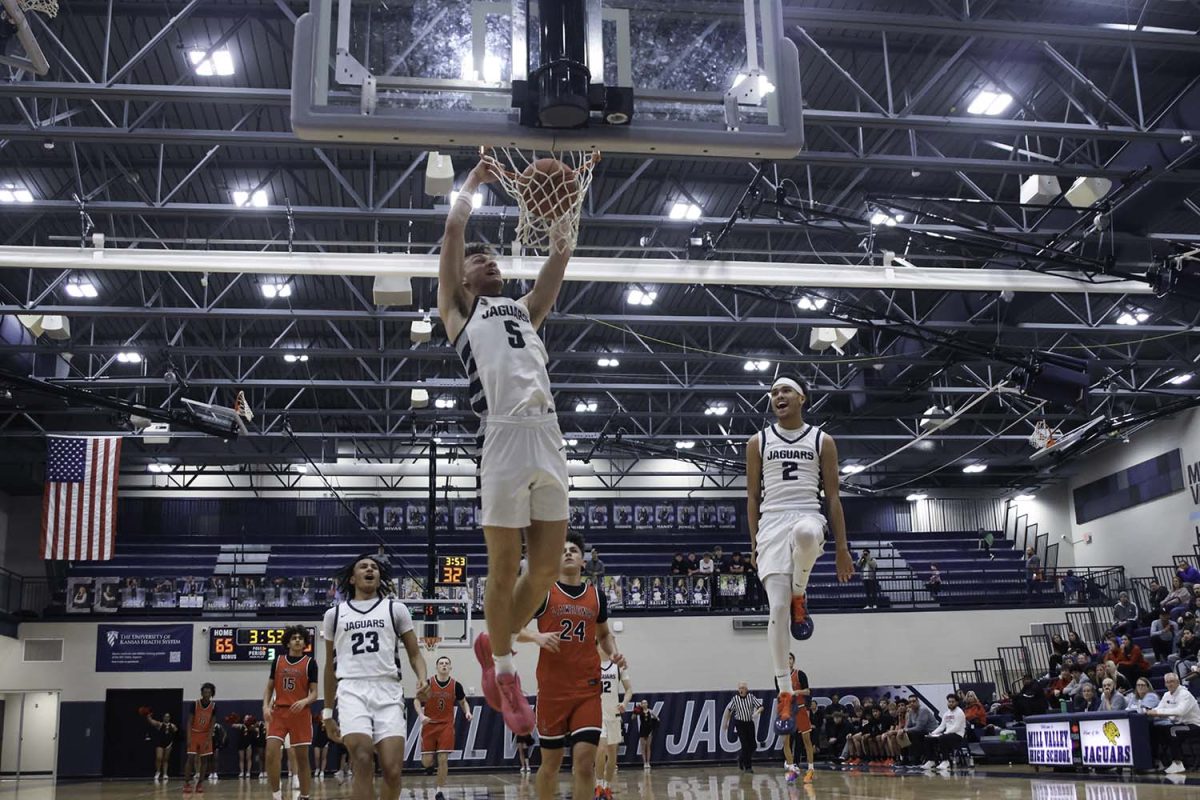 Senior Reece Reidel celebrates a dunk after being assisted by senior JaKhai Carter