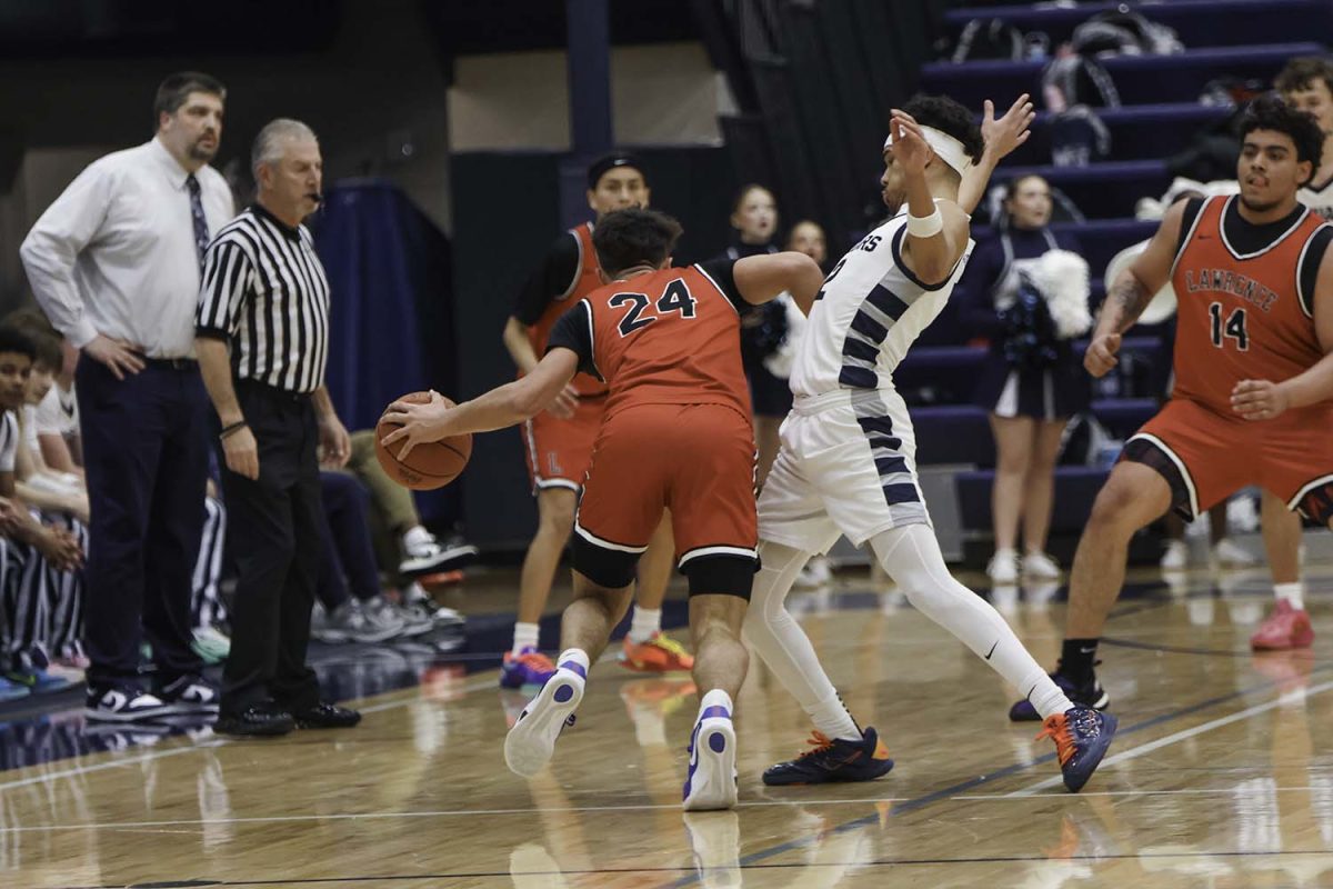 Senior JaKhai Carter leans back to keep his balance after being pushed by a member of the other team