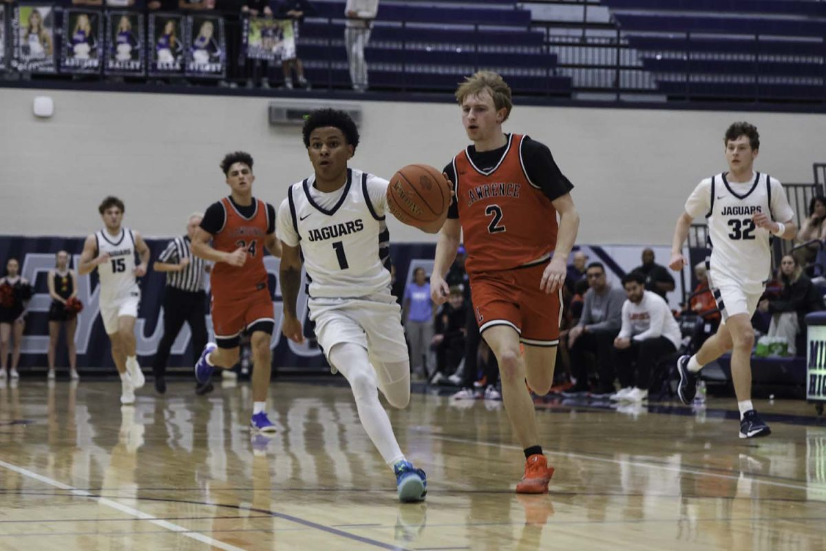 Senior Daniel Davis dribbles down the court 