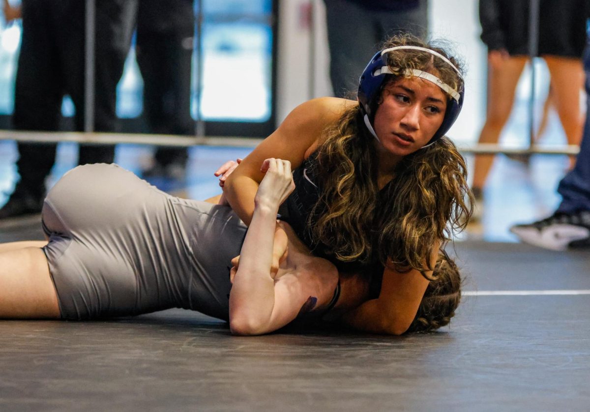 Eyes up, junior Azaria Vazquez rotates her opponent to her back to achieve the pin. 