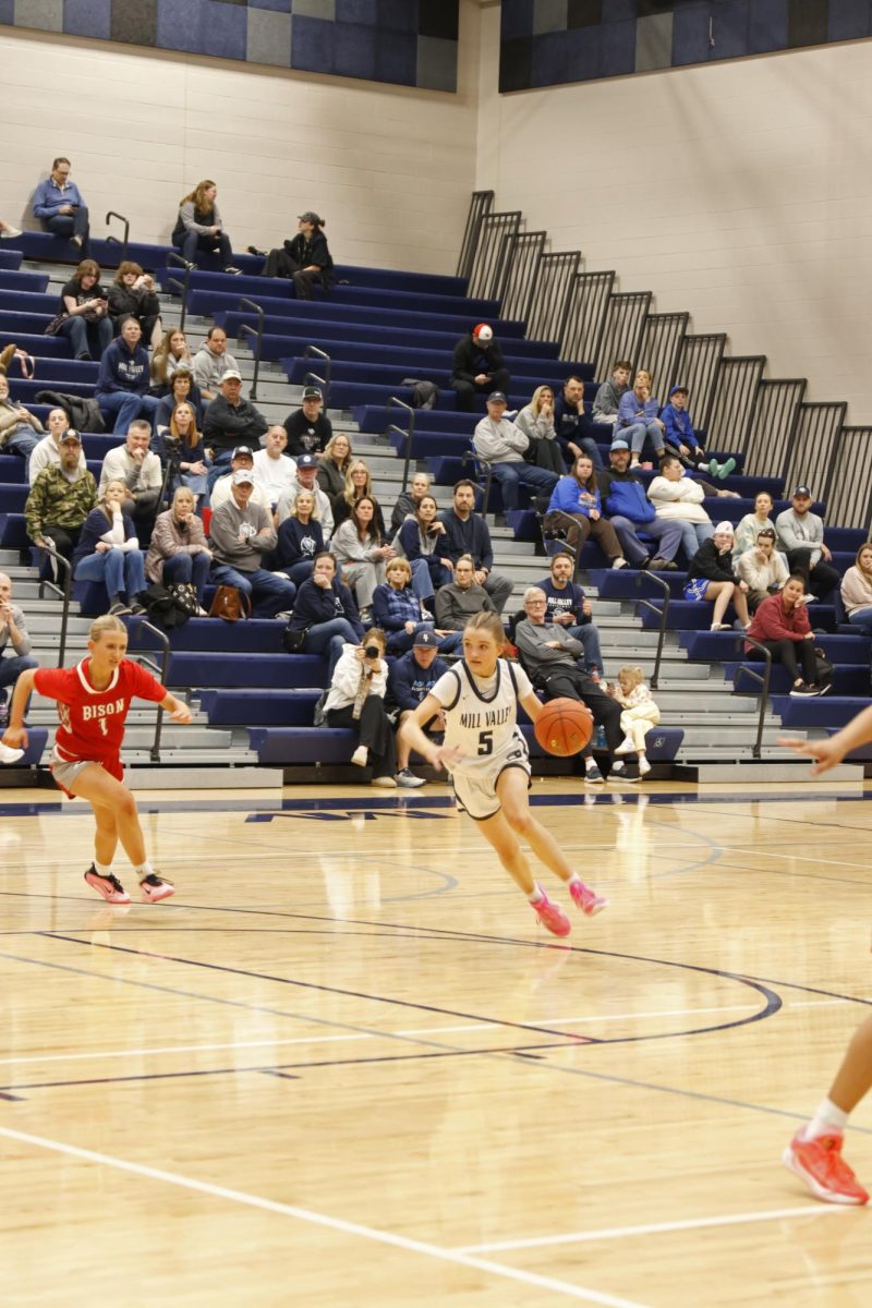 Dribbling down the court, sophomore Elin Diskin goes past the defender.