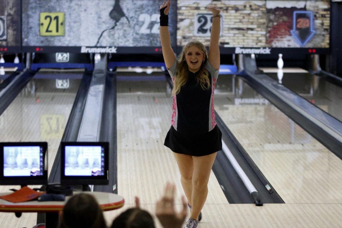 Picking up a split senior Abby Haney cheers to her team.  
