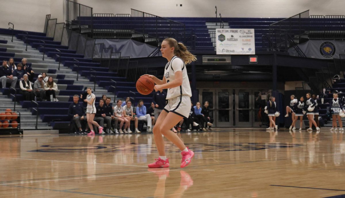 Dribbling, junior Riley Marshall gets ready to shoot.