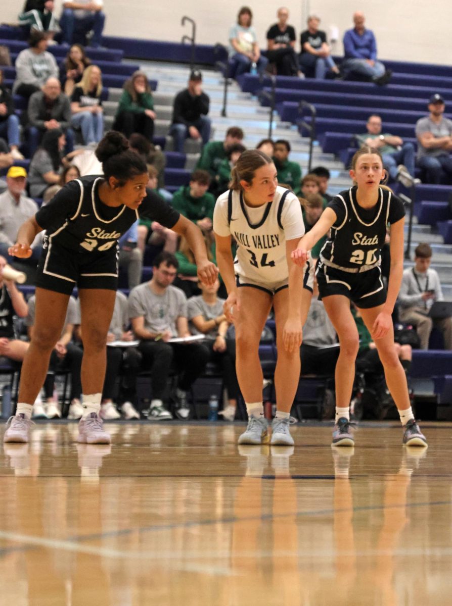 Preparing for the shot, sophomore Emily Izatt waits for the free throw.