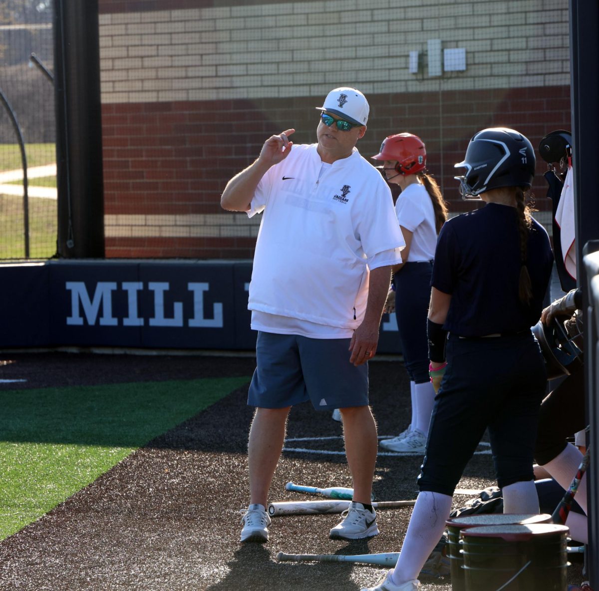 Providing guidance softball coach Kevin Mosher talks strategy with freshman Oliva clark at practice on Monday, March 9  