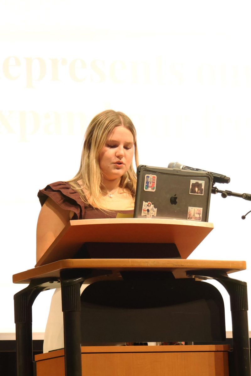 Senior leader Emma Lee delivers her speech on a pillar of the French NHS during the induction ceremony, Friday, Feb. 24. 