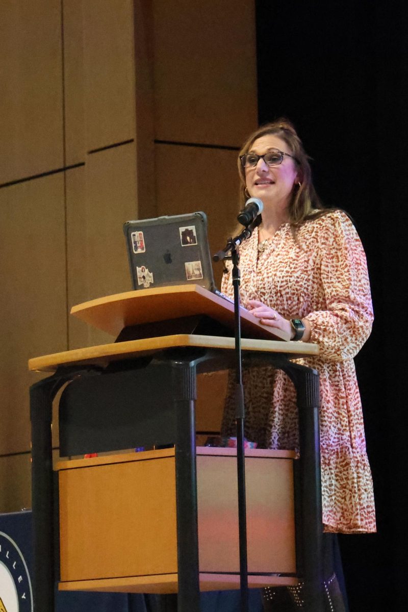 Midway into the induction ceremony, french teacher explains the achievements each student must have in order to be inducted into the French National Honor Society. 