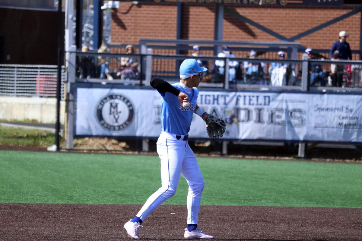Making a play, senior Blake Jay throws to first base for an out.  