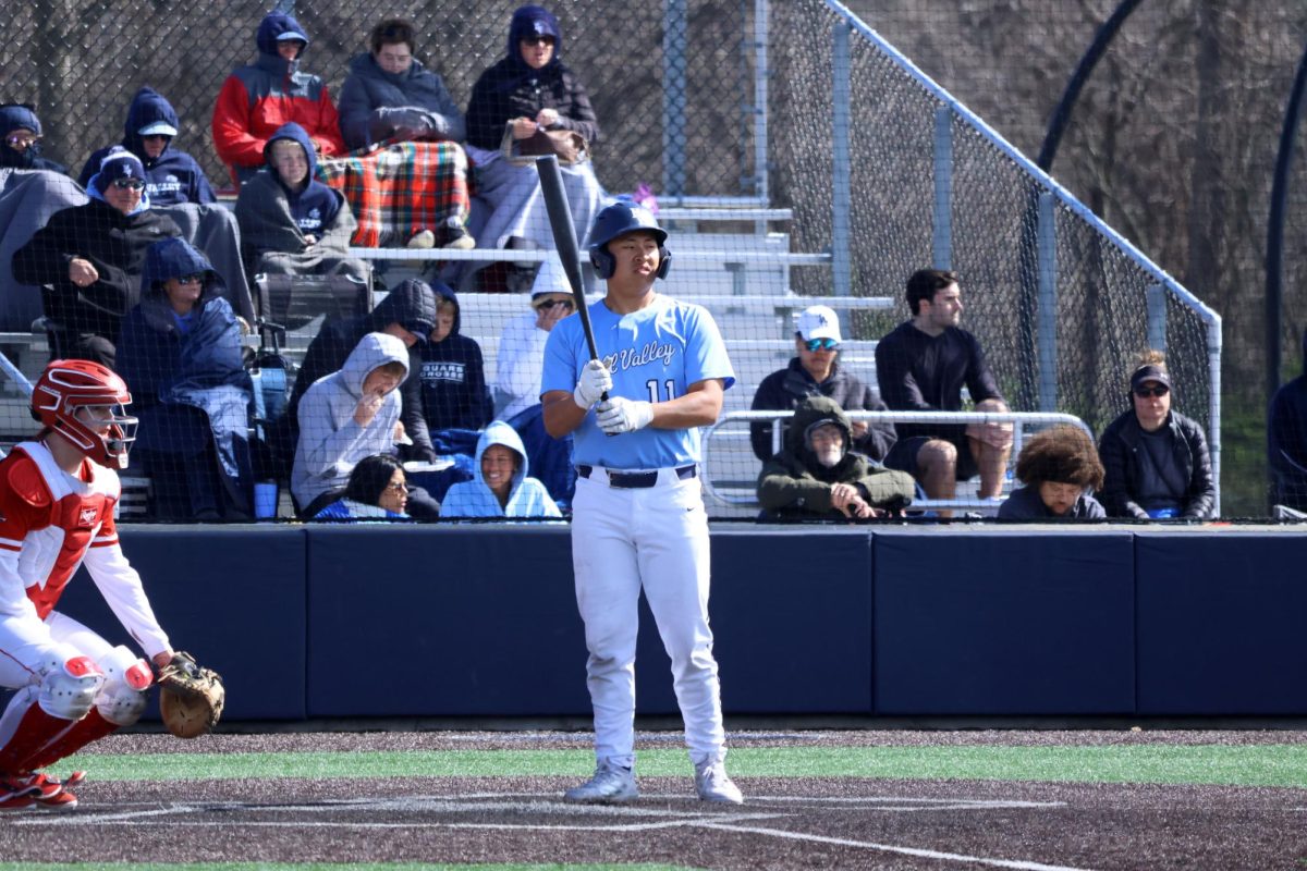 Approaching the plate, junior Josh Garcia prepares to hit. 