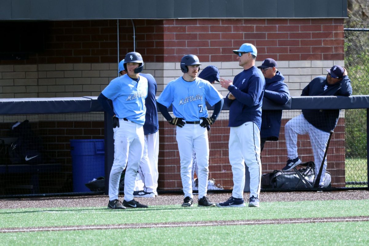 Head coach Jeff Strickland talks approach with senior Micah Ammann and junior Devin Leiker. 