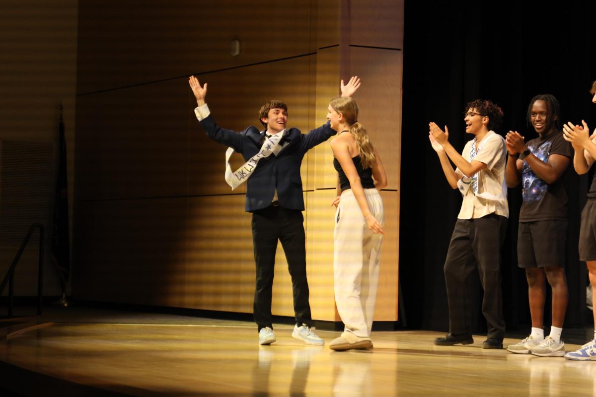 Senior Nate Petrowsky throws his arms up in celebration after winning Mr. Mill Valley. 
