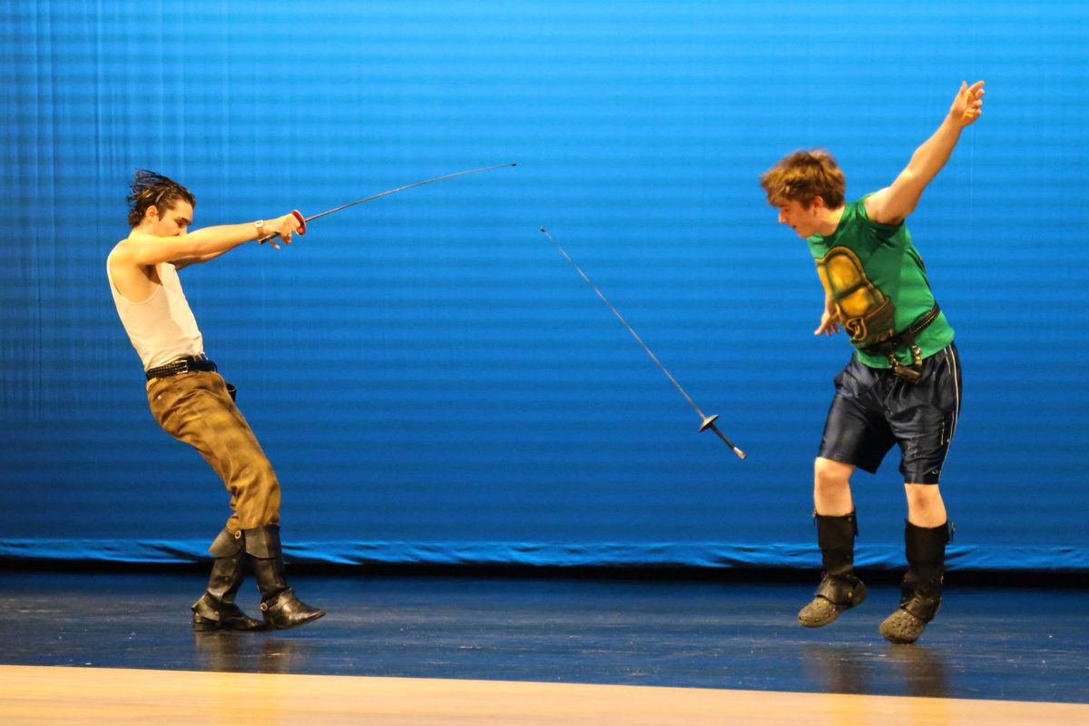 During their sword fight performance, senior Pete Williams knocks sophomore Jack Musil's sword from his hands.
