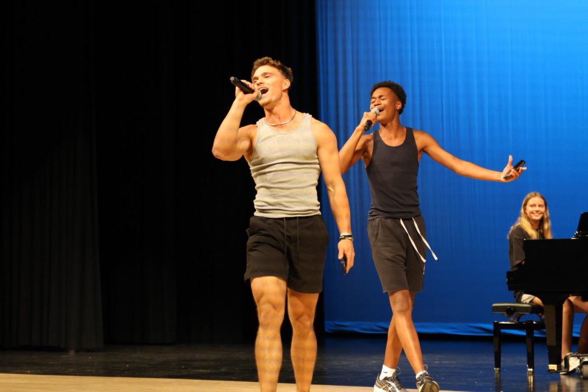 Seniors Landon Stockwell and Baiabi Chongan sing together with emotion.
