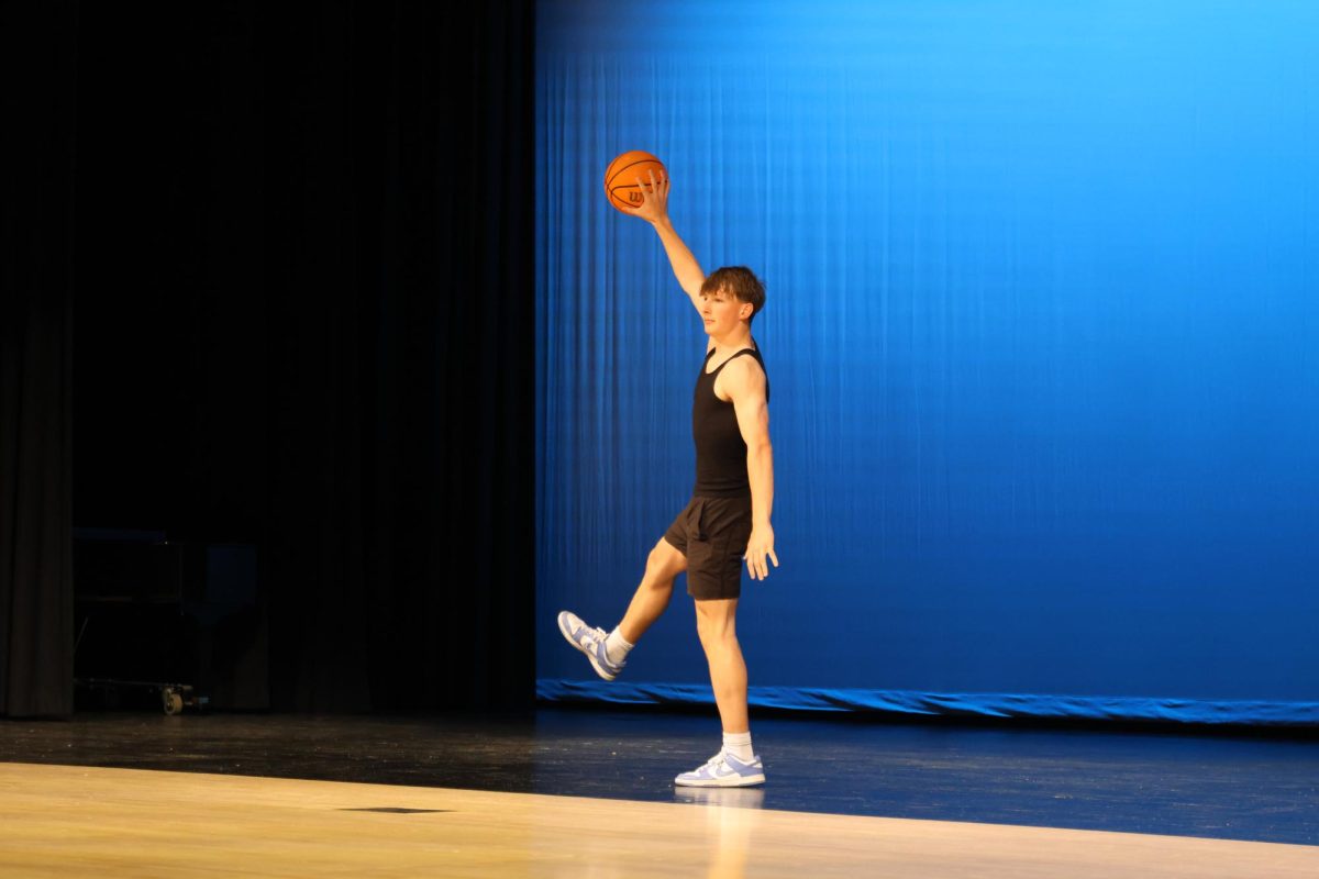 Senior Grant Kuchynka poses after performing his basketball poses for his talent performance. 
