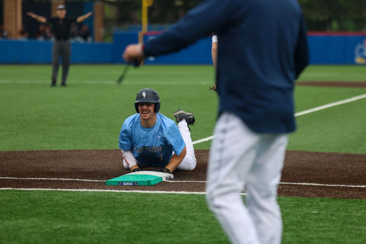 After attempting to run to second base, senior Micah Ammann slides back to first