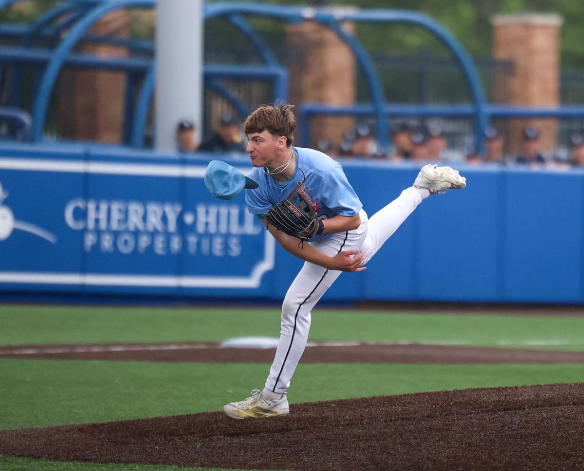 After a pitch, junior Carson Cooke looses his hat