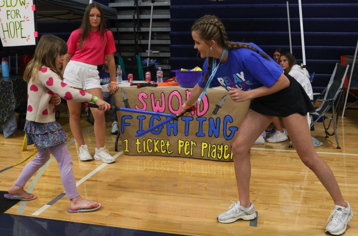 Sophomore Elin Diskin sword fights her sister.