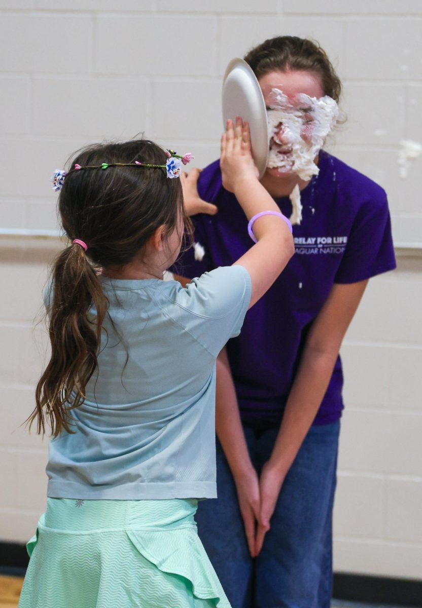 Hand outreached, relay attendee pies Ainsly Leithead in the face.