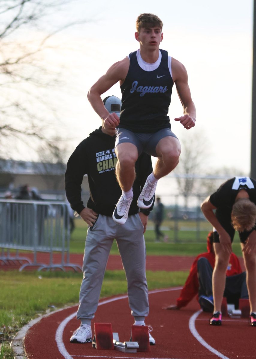 In the air, junior Braydon Jones warms up for his race.