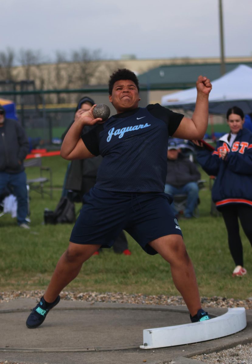 Arm backwards, freshman Braylon Nelson throws the shot put ball.