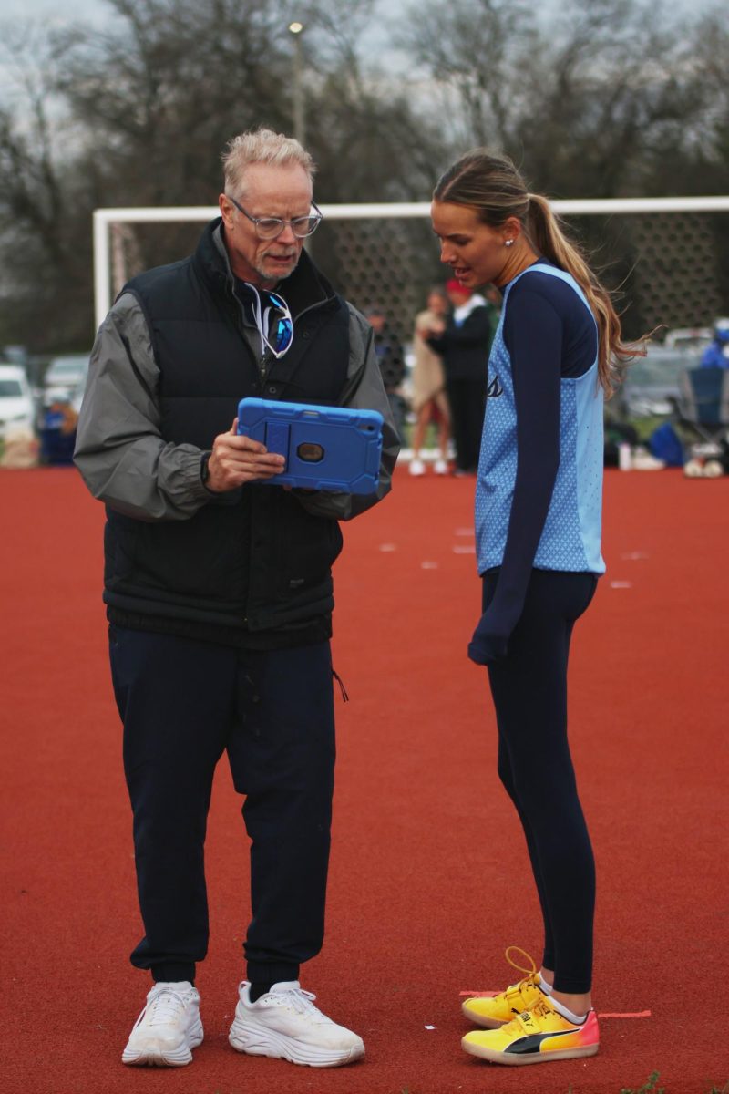 Leaning in, senior Milena Strathman receives feedback from her coach.