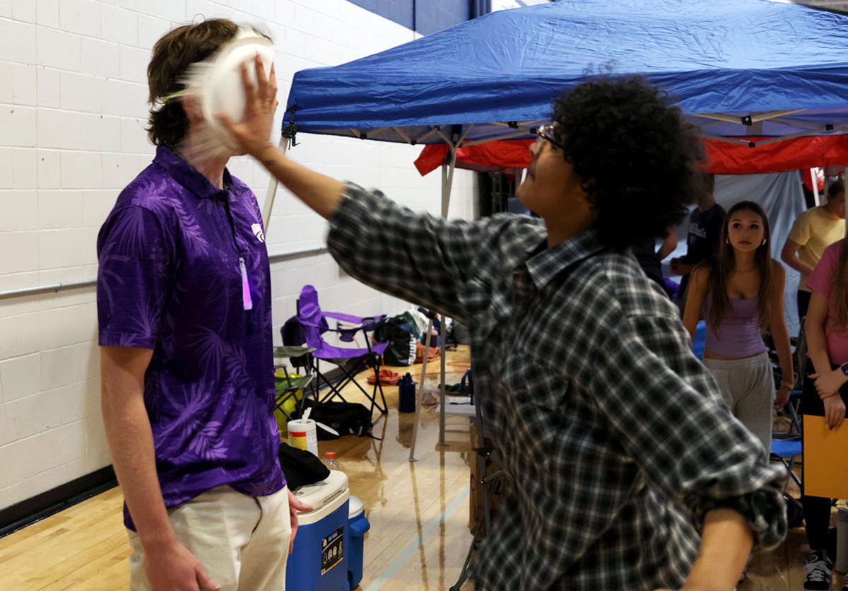 Senior Ellyott Edwards pies senior Gabriel Sommerfeld at an RFL booth, Saturday, March 28.