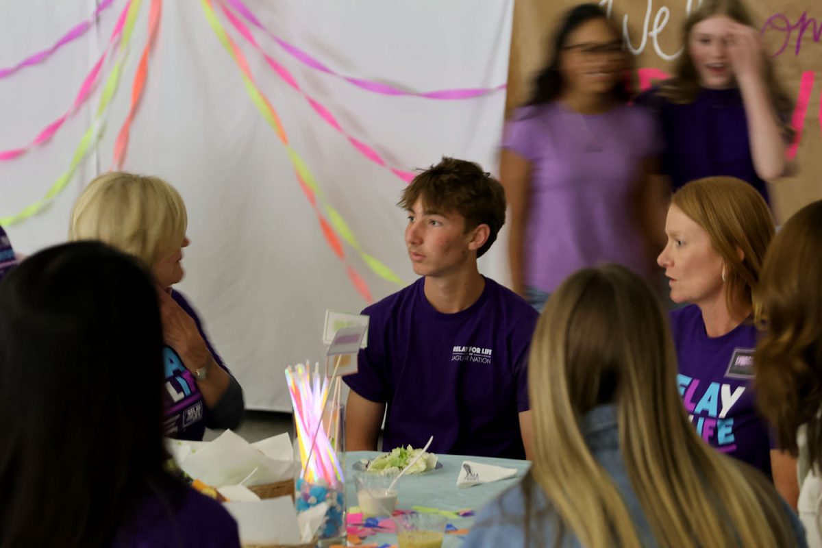 Sophomore Kohen Dick eats at the survivor dinner with his family, Saturday, March 28.