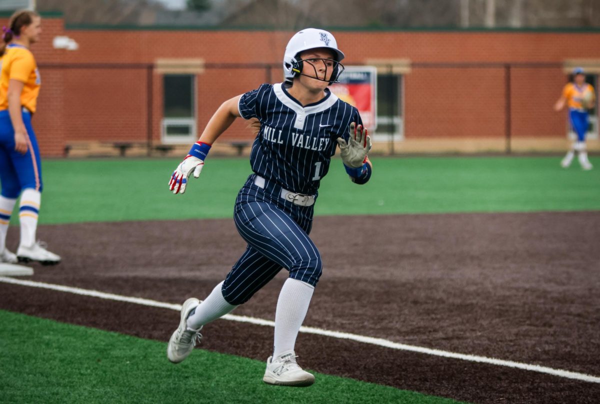 Leg extended, sophomore Logan Waters runs full speed to home base. 