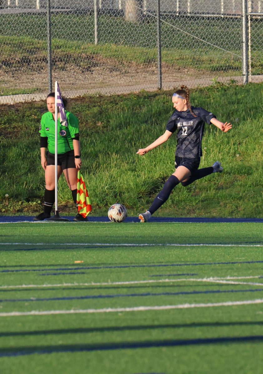 Eyes locked on the ball, senior Sydney Nash takes a corner kick looking to create a scoring opportunity.  
