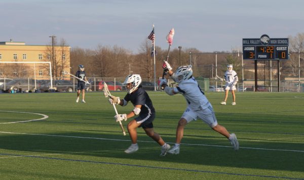 With his stick up, sophomore Joseph Adcox gets ready to slash his opponent.