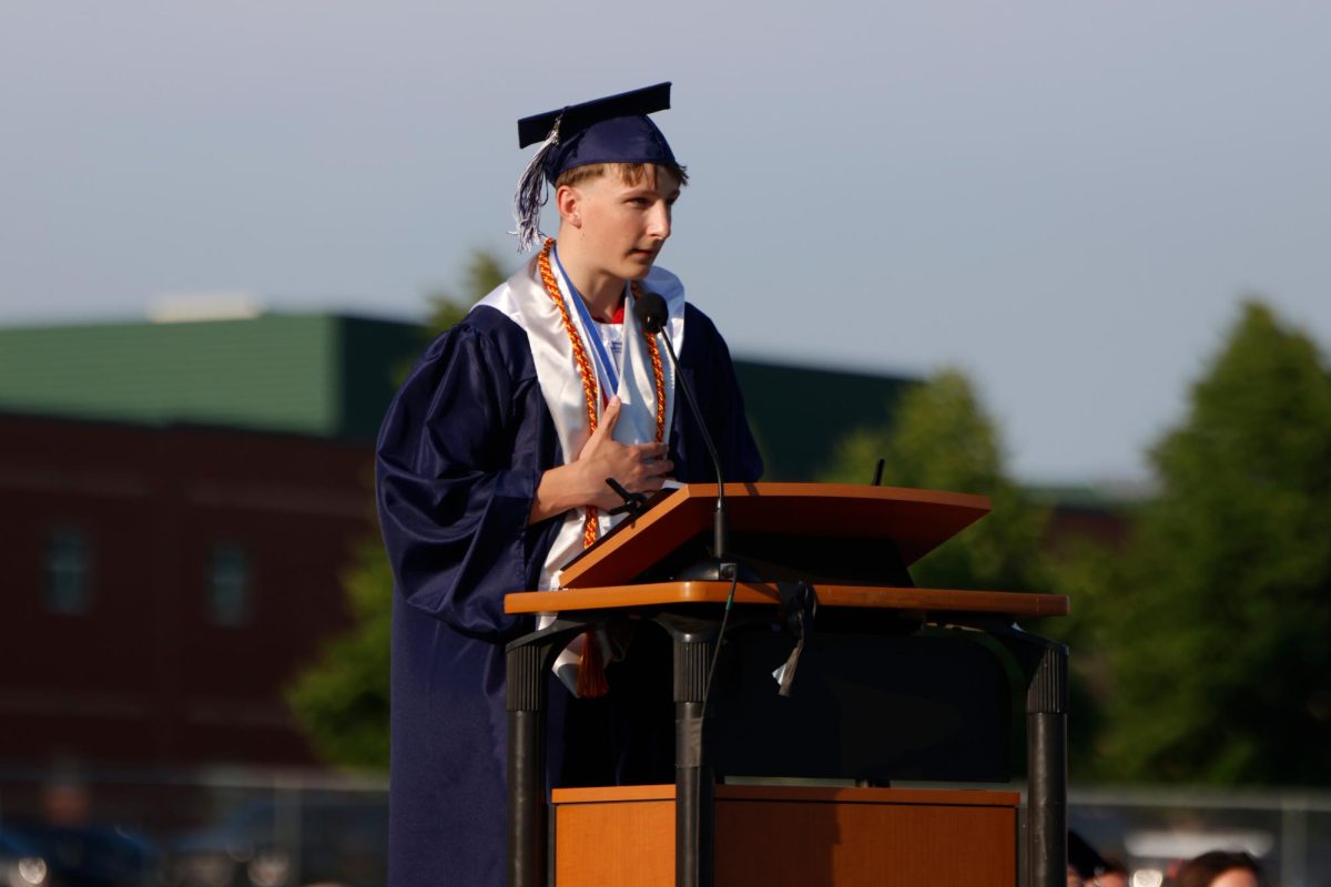 Putting a hand to his heart, senior Grant Kuchynka gives his valedictorian speech. 