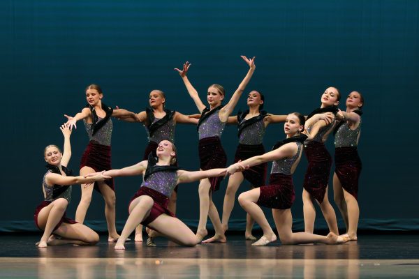 Looking into the crowd, the dancers perform their jazz routine.