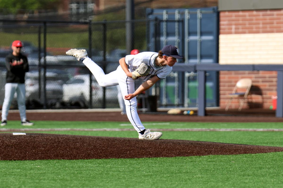 Senior Dylan Mothersbaugh warming up to start the game as the starting pitcher