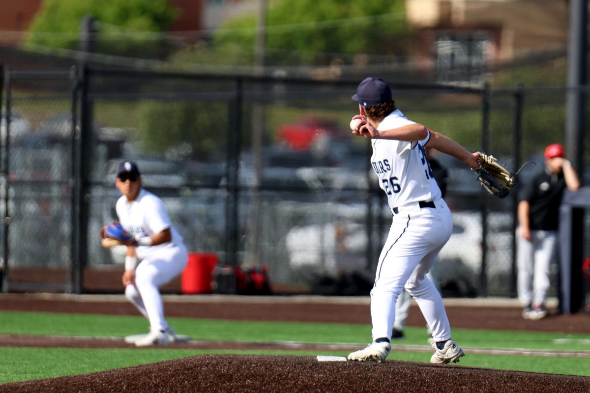 Senior Dylan Mothersbaugh throws to first to catch a runner stealing
