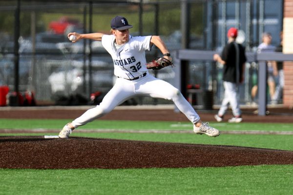 Junior Carson Cooke warms up on the mound after a pitching change