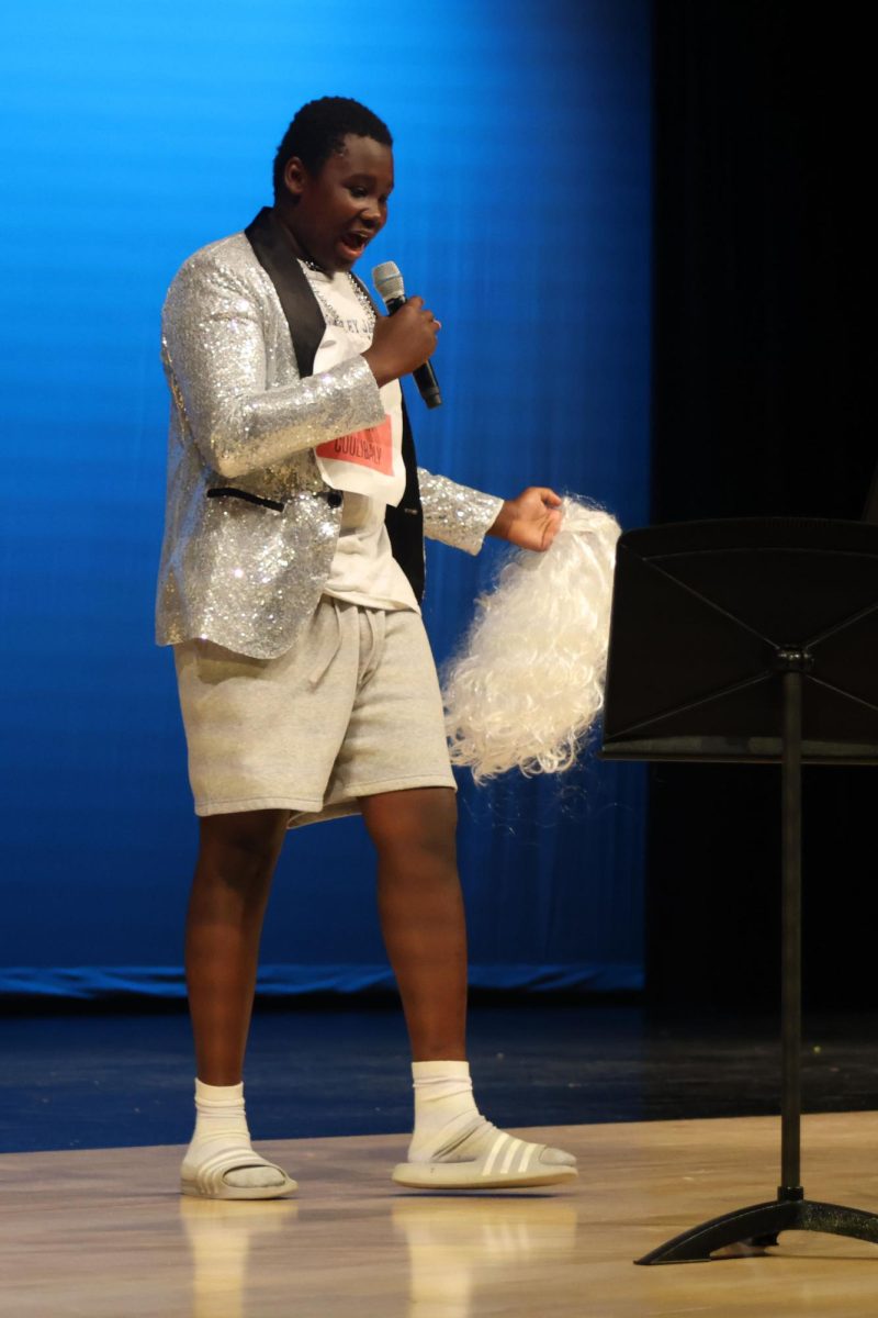 Sophomore Lacina Coulibaly makes the crowd laugh through school-related jokes during his comedy performance in the talent portion of Mr. Mill Valley. 