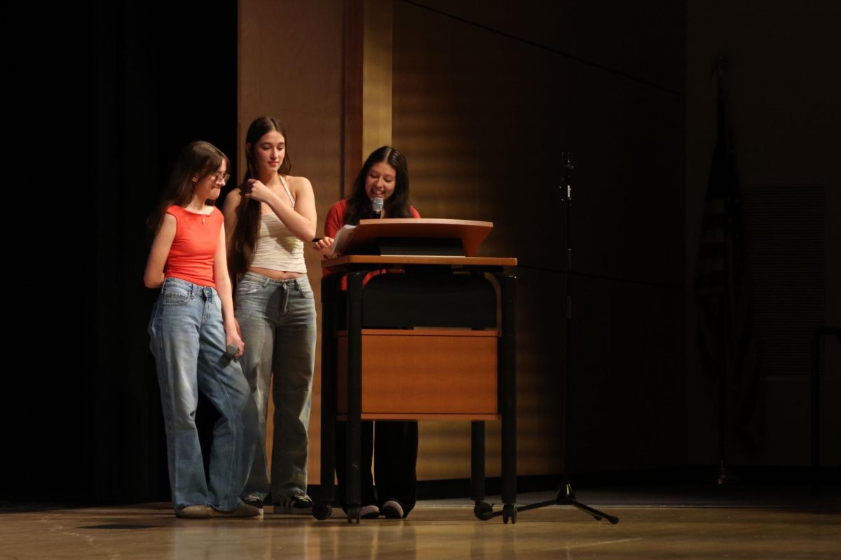 Sophomores Leah Tucker, Elynne Strack, and Junior Natalia Castillejos-Ramirez reintroduce each of the Mr. Mill Valley candidates for the formal wear/interview round of the competition. 