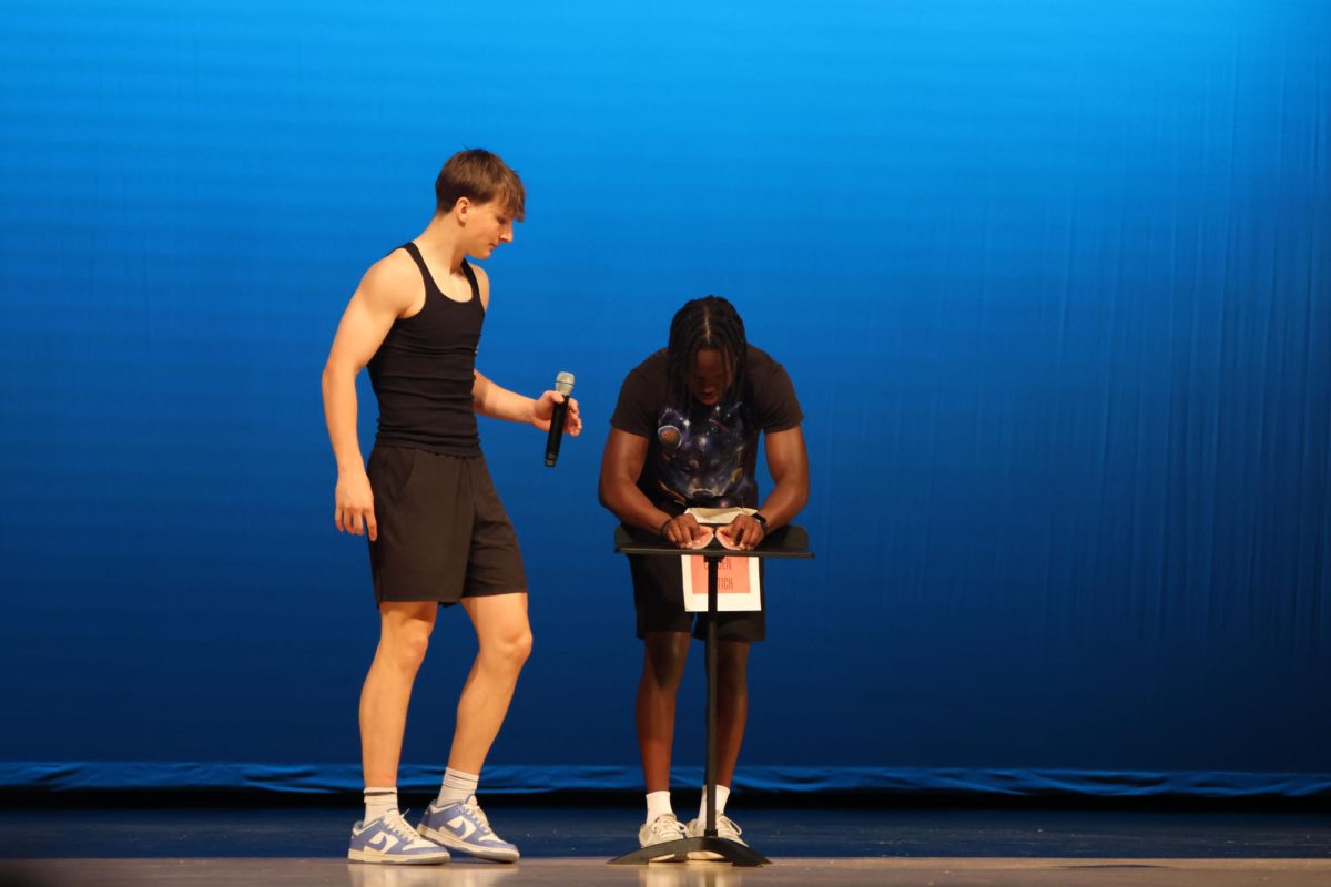 With the help of senior Grant Kuchynka, senior Cayden Rotich wows the crowd with his magic skills through card tricks. 